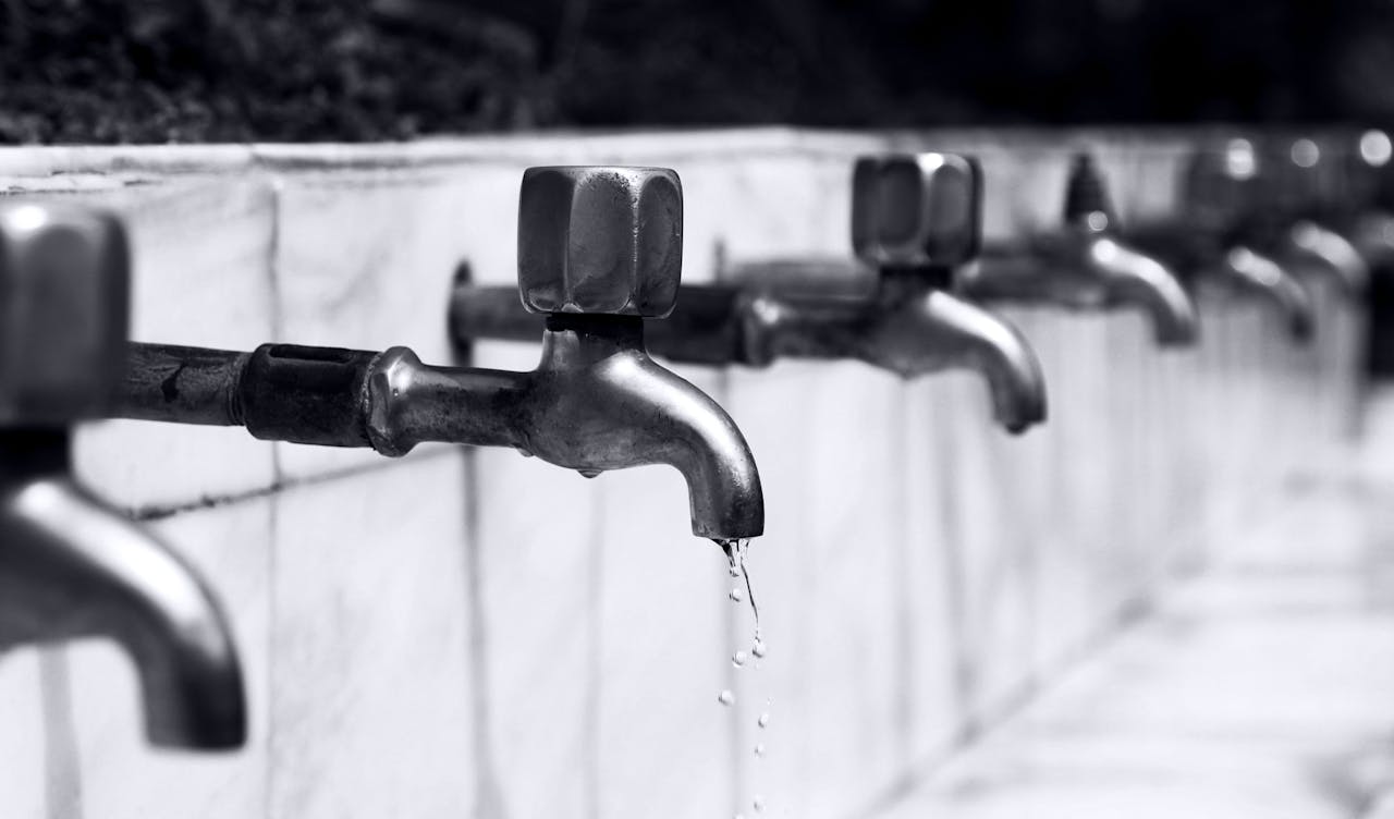 Row of faucets representing emergency plumbing repair services"