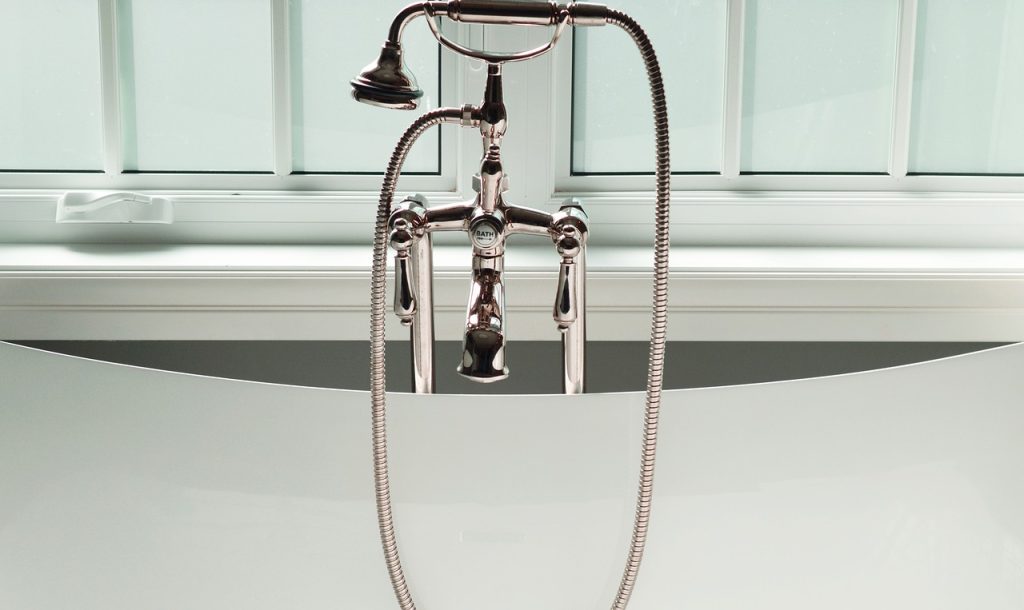 Modern bathroom faucet representing general plumbing services